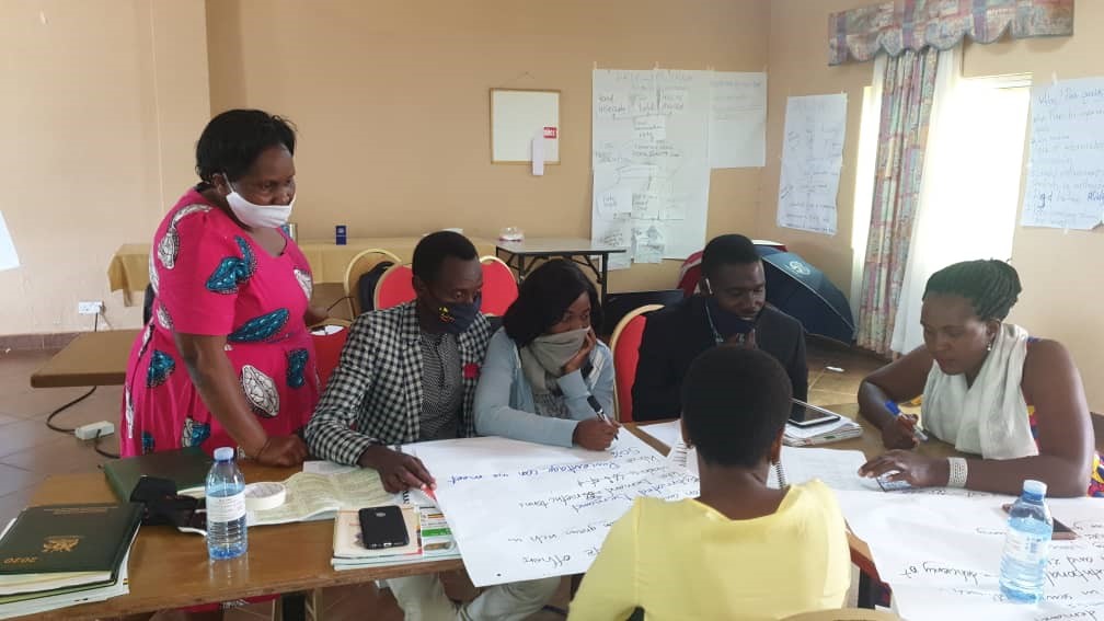 UCA facilitator Mrs. Justine Ssesanga monitoring the Trainees during the group discussion Image